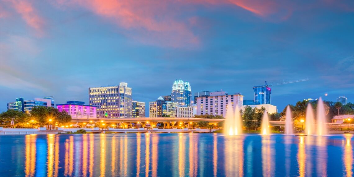 Orlando, Florida, USA aerial cityscape towards Lake Eola at dusk.