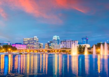 Orlando, Florida, USA aerial cityscape towards Lake Eola at dusk.