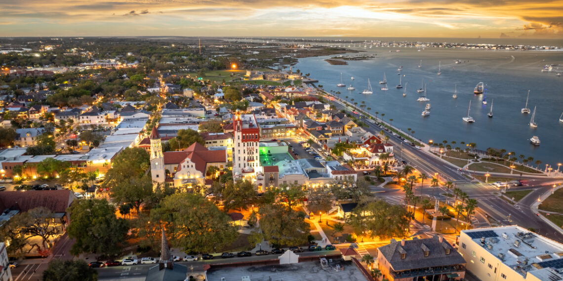 Aerial view of St. Augustine, old city in Florida. American architecture at night. SSUCv3H4sIAAAAAAAACoRTwW7bMAy9D9g/BDovmCxZib3jTi2wfUGxA20psRBZMiS521Dk30fZVqYU7XYwYD6Sj+Qj9fLxw25HOgi6J192L8lCWxszh+ghamcRpp823CsrlS+RZ88PtARAl5aSOjqvwZRgB7EfLIwKQTsbk+Dr4iQhQpyDCkUvYZhjVD5E118Q5pllclYKBKoMjC7EaXDRhRKd9K8IKa+o0kNUZ2zrrk7W4Gm1d9mxODEDXeTrrI3U9hw+fwMrR/CXQLZCa69zl8IeNHbrdb/rcjzJQWsH79A/WplkT3K9wfpdh14ZA1a5uSBcf37c9D8r2/9Oc12Lib0yClZdn9ZQcvmJqo6LAlsQzFK7QpFn14MJr7QDPYGHu7wJR8UhC8TFYTmTzNS72UafuiKMsTwcMc5N0Jl0ByespDI+QAiYITNerg4FcmNRyrq4jEVWViJxt8msOG+PlIr0VS2jvCHliQ3LihadtqLzZBxIlYreVvP6+KpjXTNBed3c9vP3DtF3PDBa+u5P8igobWlbsSJ5u87VxxrWrq58Jmn3o8YW/tsWZ1VF67eZBTtUTGzMd68N87X8x2sjmEkPqCRvb1vLzKRitD0I0YjlGDdOnTol0LYC5+H7E2diXzec7zuhuj07dSBE30DHasy6/gEAAP//AwAonGnVfwQAAA==
